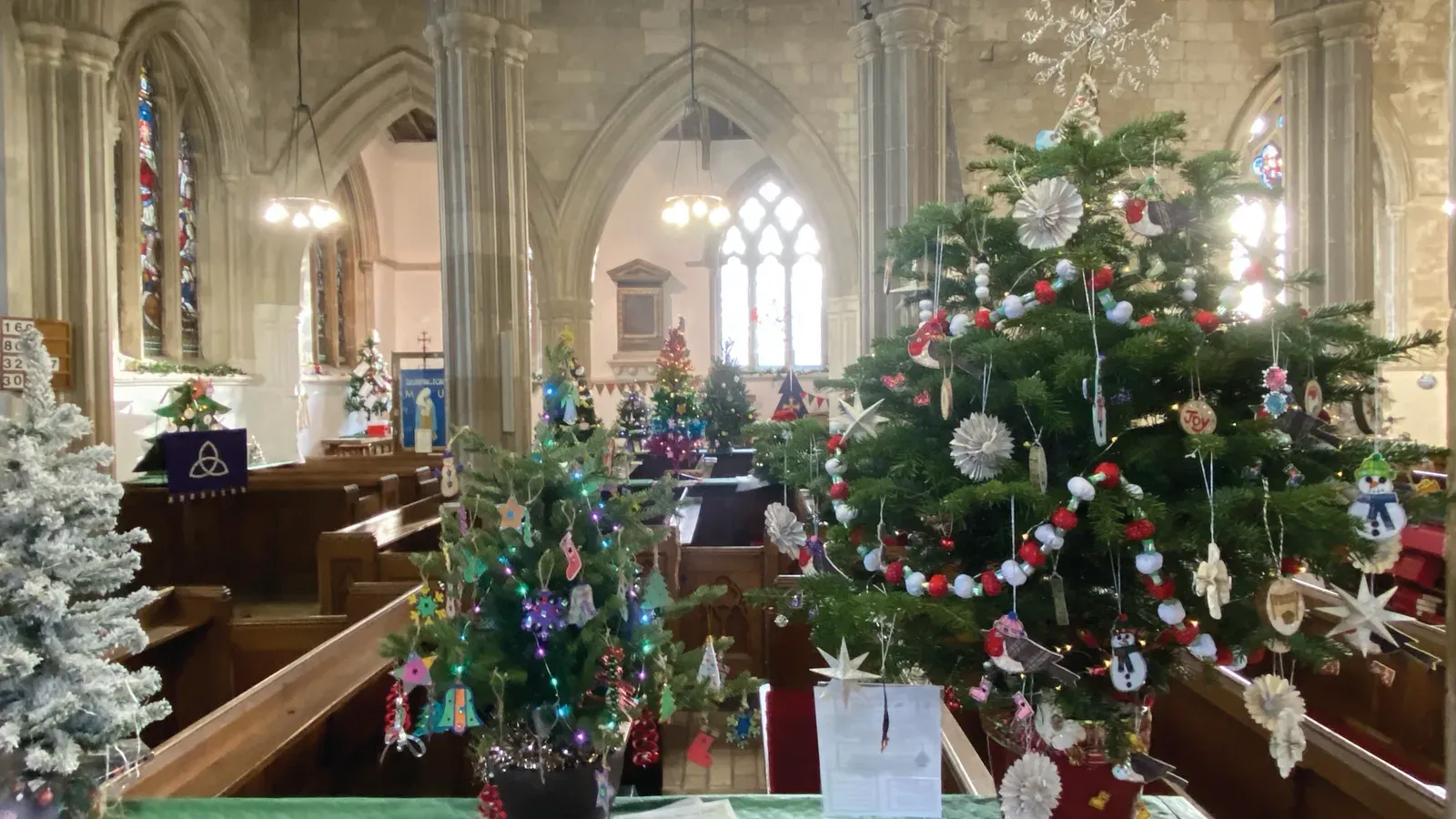 Decorated Christmas trees inside St Mary & St Michael