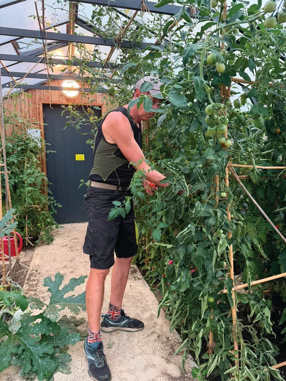 Volunteer working among plants at Clay Farm Community Garden