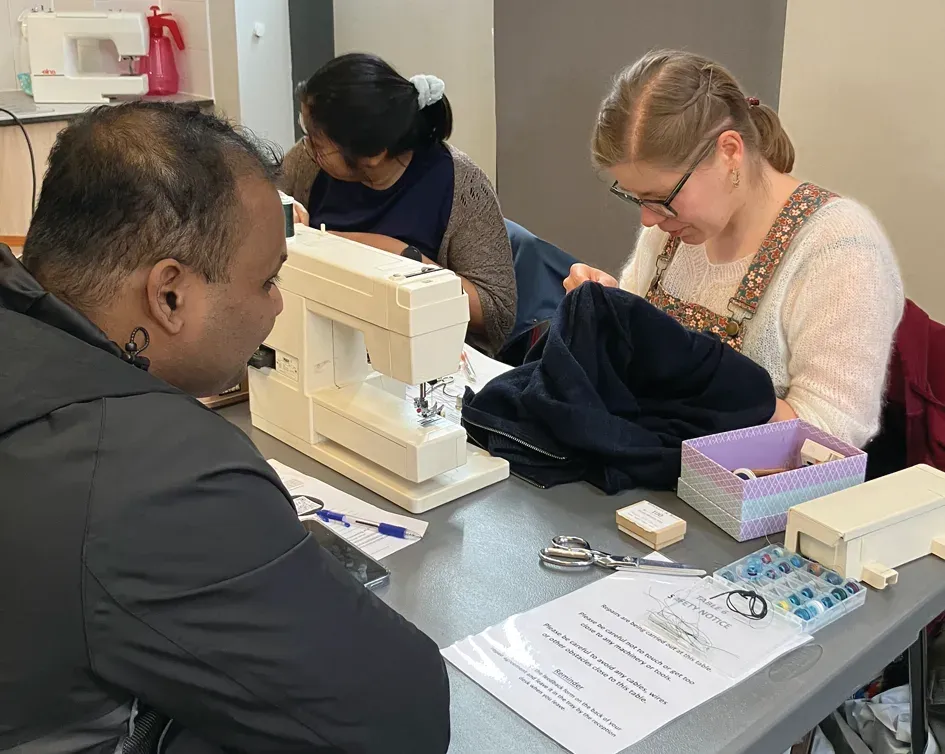 People mending clothing at Trumpington Repair Café