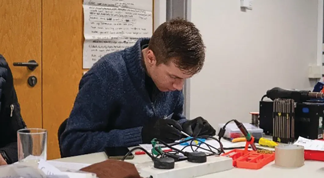 Volunteers repairing items at Trumpington Repair Cafe